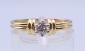 An 18 ct gold diamond solitaire ring. Ring size N/O. 2.7 grammes total weight.