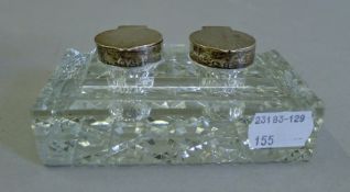 A silver mounted glass double inkwell. 11 cm wide.
