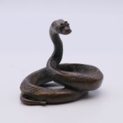 A bronze model of a snake. 4.5 cm high.