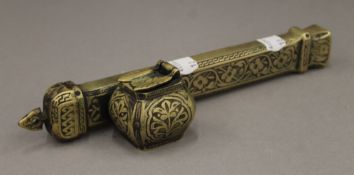 An Ottoman brass travelling inkwell and pen case stamped with Tughra to one end. 23 cm long.