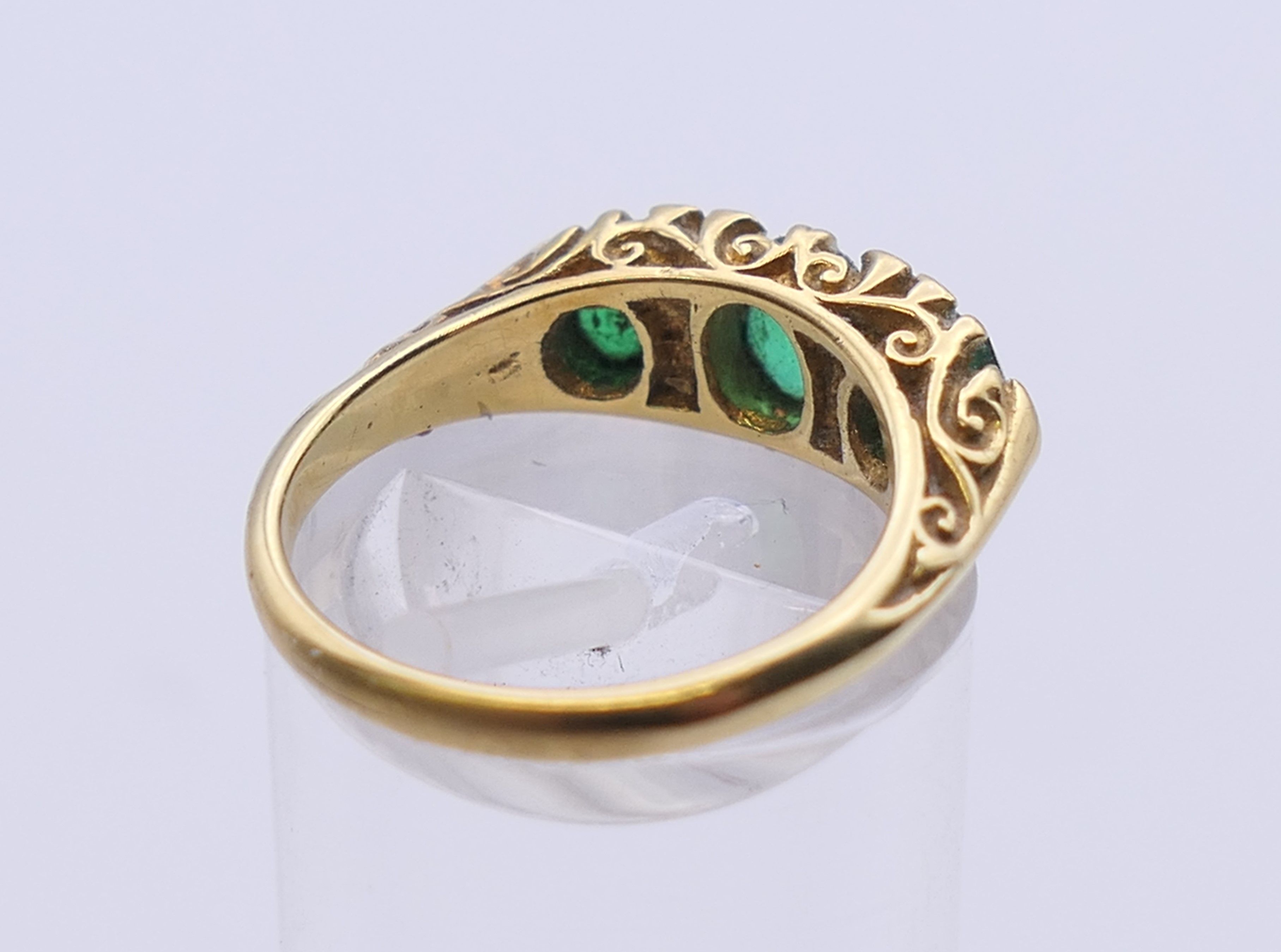 An unmarked gold emerald and diamond ring. Ring size L. 5 grammes total weight. - Image 3 of 5