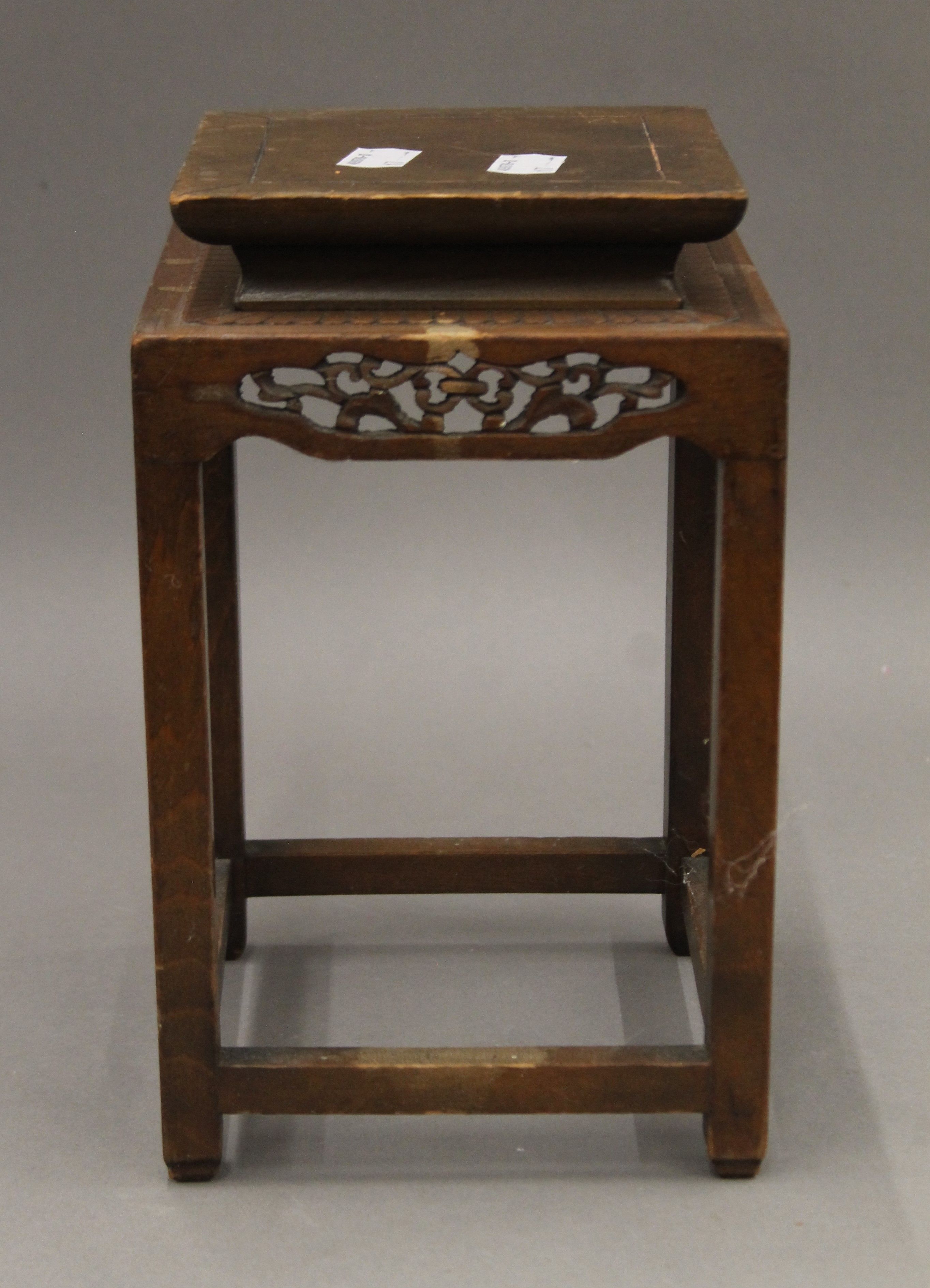 A Chinese carved wooden stand. 24 cm high.
