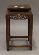 A Chinese carved wooden stand. 24 cm high.