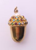 An unmarked gold acorn form pendant set with various gem stones. 3 cm high. 6.