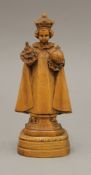 An oak carving of a young saint. 17.5 cm high.