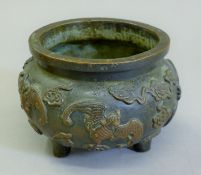 A Chinese bronze censer decorated with bats. 12.5 cm diameter.