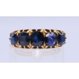 A 19th century unmarked gold five stone sapphire ring. Approximate sapphire weight 5.5 carats.