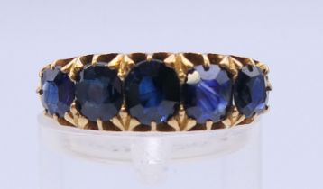 A 19th century unmarked gold five stone sapphire ring. Approximate sapphire weight 5.5 carats.