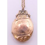 A 9 ct gold chain with a 9 ct gold back and front locket. The locket 3.5 cm high.