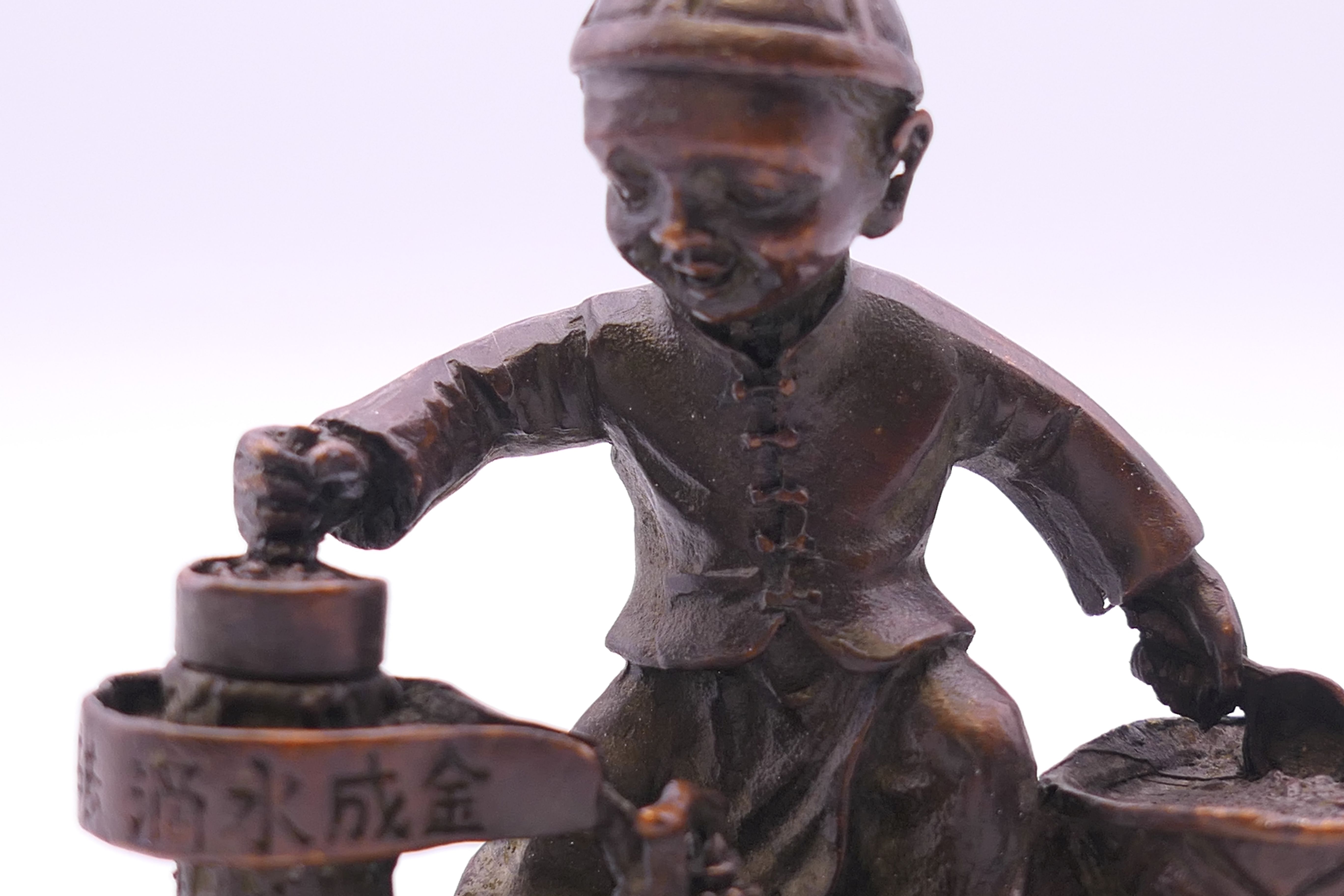 A bronze model of a boy cooking. 6 cm high. - Image 2 of 4