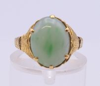 A Chinese jade set gold ring. Ring size I/J. 3.1 grammes total weight.