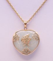 A Chinese jade and unmarked gold pendant on chain. The pendant 2.5 cm high. 10.