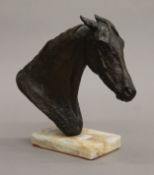 A bronzed horse head 'Reality', signed J (Jean) Walwyn, on a plinth base. 21 cm high.