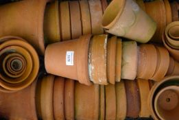 A quantity of terracotta garden pots. The largest 18.5 cm high.