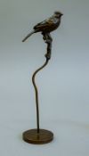 A bronze model of a bird on stand. 17.5 cm high.