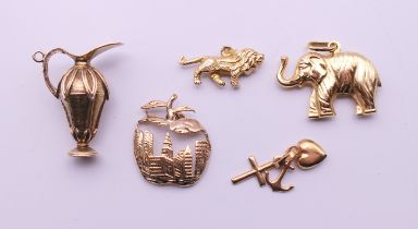 Five 9 ct gold charms. The elephant 2.5 cm wide. 16.7 grammes.