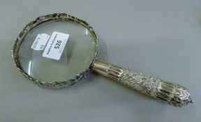 A silver magnifying glass. 20.5 cm high.