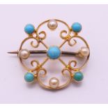 A 19th century 15 ct gold turquoise and pearl brooch. 2 cm diameter.