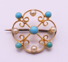 A 19th century 15 ct gold turquoise and pearl brooch. 2 cm diameter.