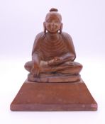 A wooden model of Buddha. 10 cm high.