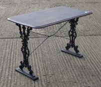 A cast iron wooden topped table. 106 cm long.