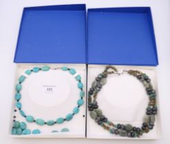A boxed turquoise necklace and a boxed two strand mineral necklace. The former 41 cm long.