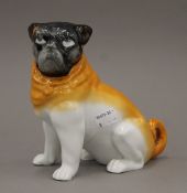 A 19th century porcelain model of a pug dog. 16 cm high.