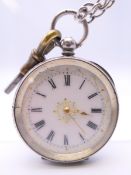A ladies silver pocket watch on long guard chain. 3.5 cm diameter.
