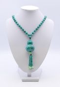 A turquoise ground necklace. 88 cm long.