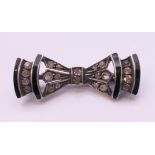 An Art Deco silver black enamel and paste brooch. 3 cm wide.