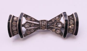 An Art Deco silver black enamel and paste brooch. 3 cm wide.