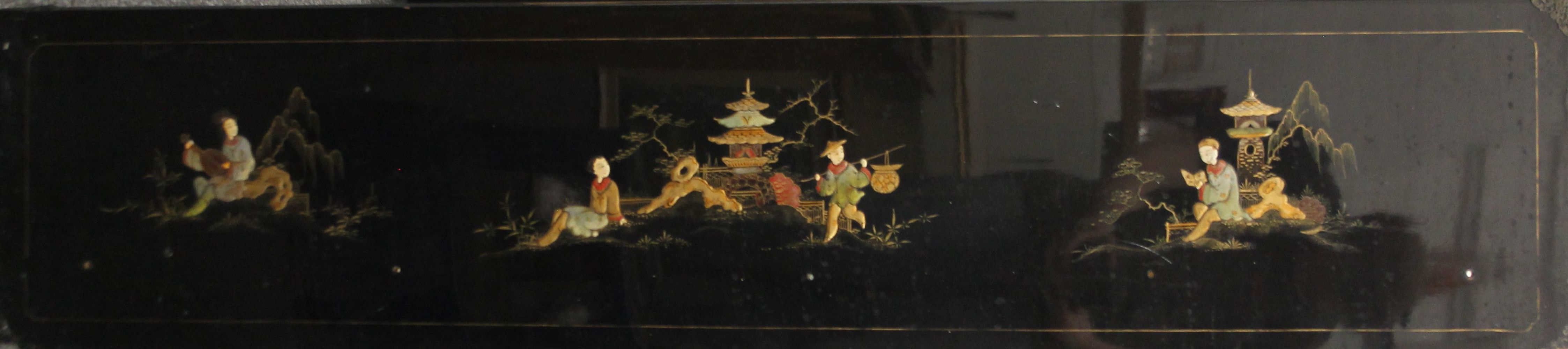 A chinoiserie lacquered panel. 136.5 cm long.