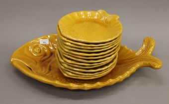 A quantity of Vallauris pottery fish plates. The largest 58 cm long.