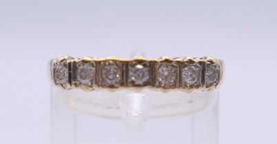 A 9 ct gold seven stone diamond ring. Ring size P. 2 grammes total weight.