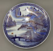 A 19th century Japanese gilt heightened blue and white porcelain charger. 45 cm diameter.