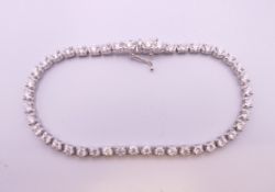 An 18 ct white gold diamond line bracelet. Approximate diamond weight 3.5 carats.