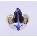 An 18 ct gold tanzanite and baguette diamond ring. Ring size O/P.