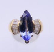 An 18 ct gold tanzanite and baguette diamond ring. Ring size O/P.