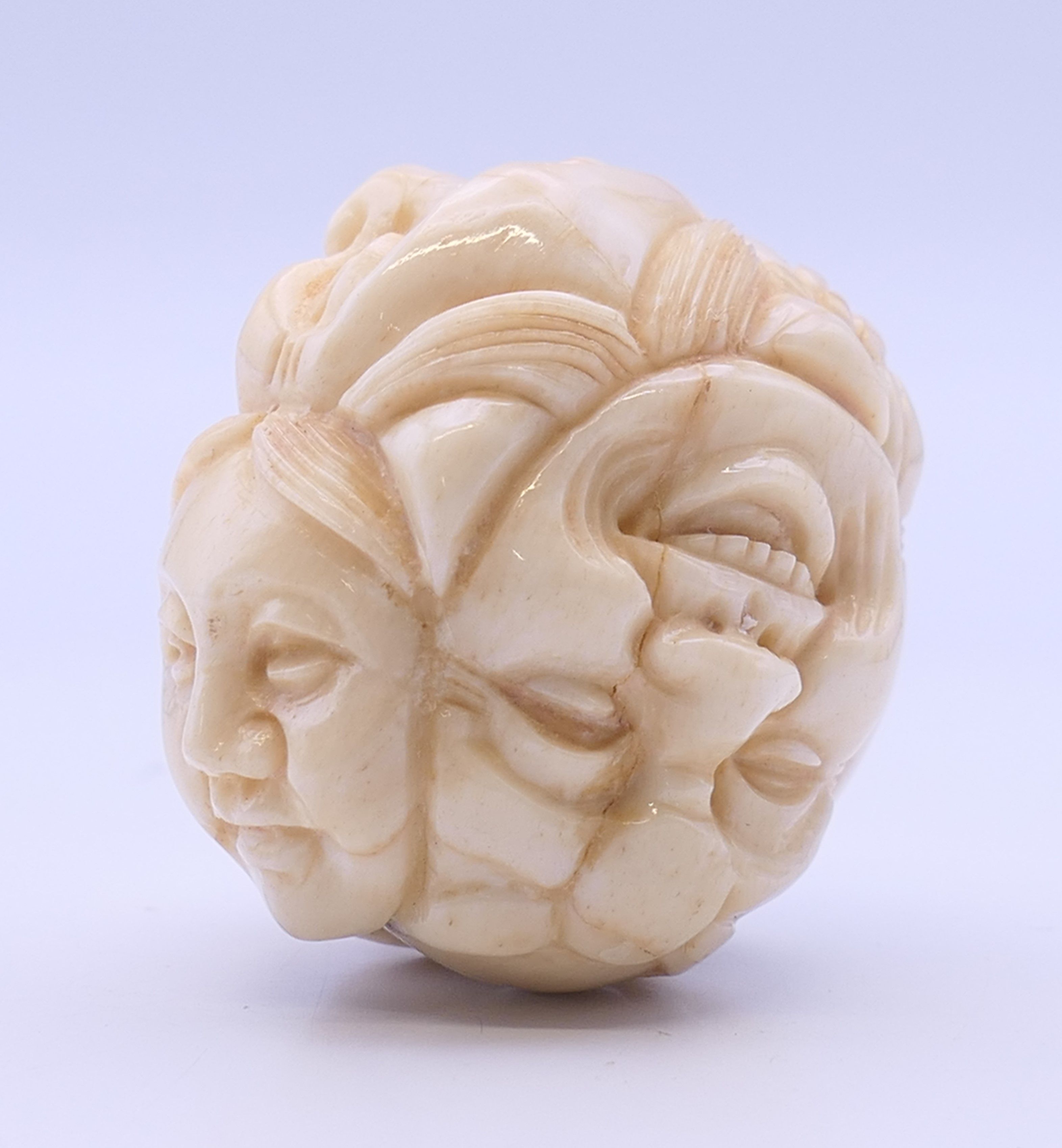 A bone carving formed as various faces. 3.5 cm high. - Image 3 of 4