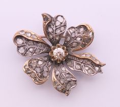 A Victorian unmarked diamond set floral brooch. 4 cm wide.