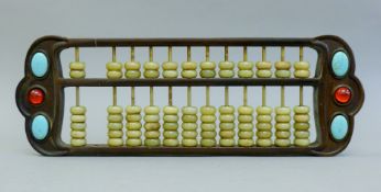 A Chinese jade mounted abacus. 42 cm long.