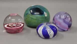 Four various paperweights. The largest 7.5 cm high.