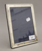 A plain silver photograph frame. 16 x 21 cm.