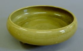 An 18th century Chinese green porcelain footed bowl. 21 cm diameter.