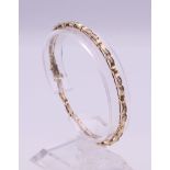 A 10 K gold diamond bracelet (with one link separated). 18.5 cm long. 6.8 grammes total weight.