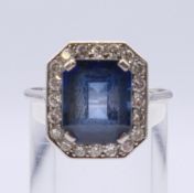An Art Deco platinum diamond and sapphire ring. Ring size S. 5.6 grammes total weight.