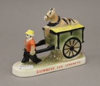 A Guinness advertising figure. 14 cm long.