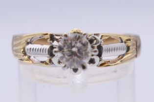 An unmarked 14 ct gold 0.5 carat diamond solitaire ring. Ring size R/S. 5.2 grammes total weight.