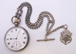 A silver pocket watch, a chain and fob. 4.75 cm diameter.