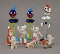 A small collection of Christmas cake ornaments and small glass clowns.
